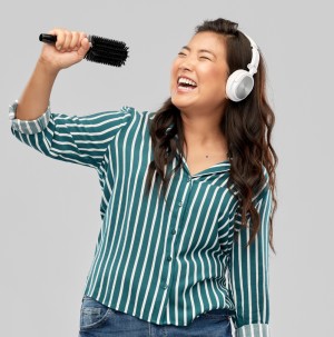 Woman singing into a hairbrush